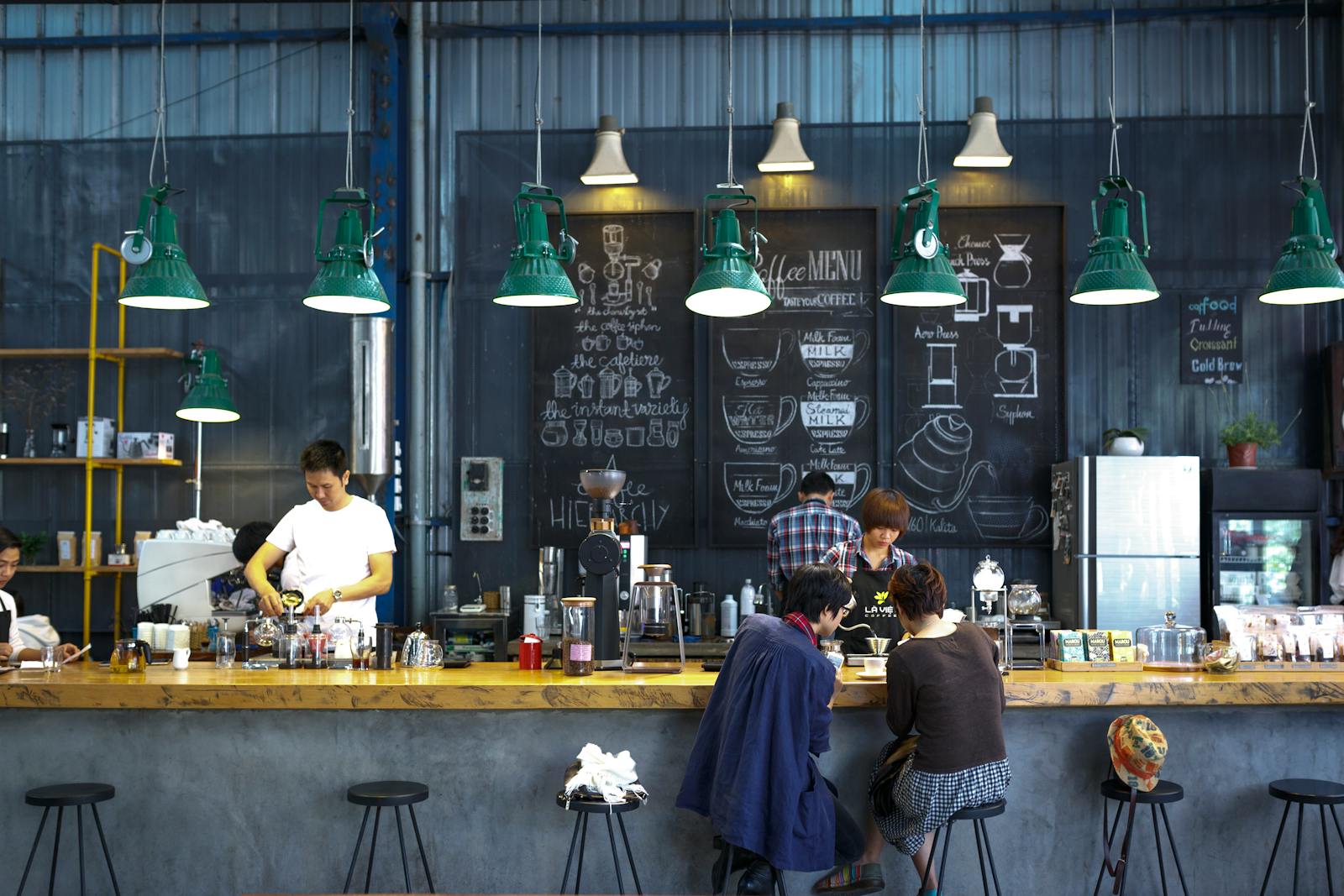 Coffee shop counter with staff serving customers