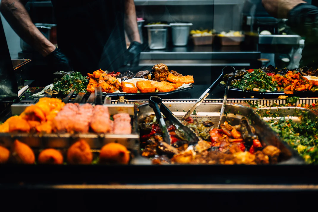 The counter at La Cuccina, trays of food under the pass